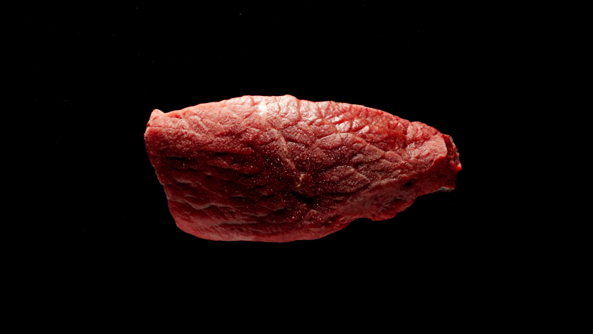 Defrosting Of A Raw Beef Steak Piece On A Black Table, Top view, Time-Lapse Royalty-Free Stock Footage #1066413643