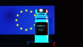Europa to launch COVID-19 vaccination campaign. European union flag and vaccin bottle. 3d Animation. Covid concept. Flag waving in wind. Black background - Powered by Shutterstock - Get 15% off with code: PIKWIZARD15