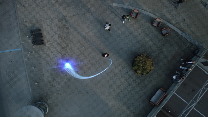 Big City Businessman Uses Smartphone, Stands on Crowded Street. E-Commerce Visualization of Information Lines Flying from Mobile Phone into Global Digital Network. Top Down Zoom out Aerial Drone Shot | Shutterstock HD Video #1066420333