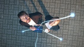 Big City Business Partners Use Tablet Computer on Crowded Street. E-Commerce Visualization of Information Lines Flying from Tablet into Global Digital Network. Top-Down Zoom out Aerial Drone Shot - Powered by Shutterstock - Get 15% off with code: PIKWIZARD15