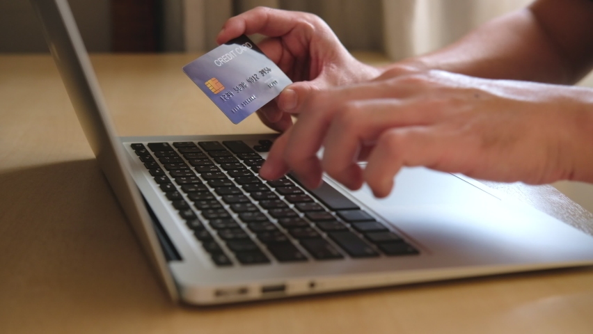 Men hand holding credit card and type payment information on keyboard for order online shopping. Internet technology and Digital market place E-Commerce lifestyle concept, Purchase transaction. | Shutterstock HD Video #1066420921