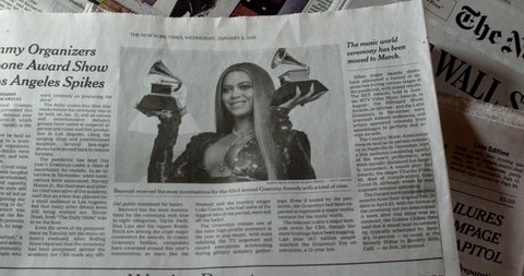 New York, New York  United States - January 5,  2021: Newspaper coverage of the Annual Grammy Awards being cancelled due to Covid-19 pandemic. Picture of Beyonce with Grammy Awards.