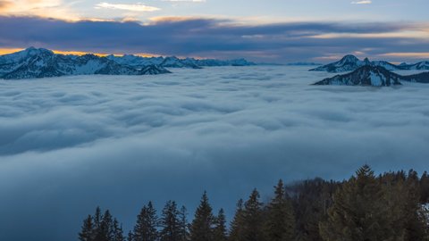 Sunset cloud movements in morning sky.A sea of fog is formed from stratus. Above the clouds over. Flat surface. Alps mountains bavaria germany wallberg karwendel nature landscapes time lapse.