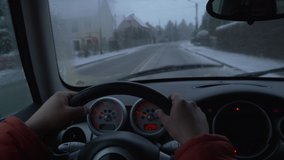view of the road during a blizzard from the driver's seat 
