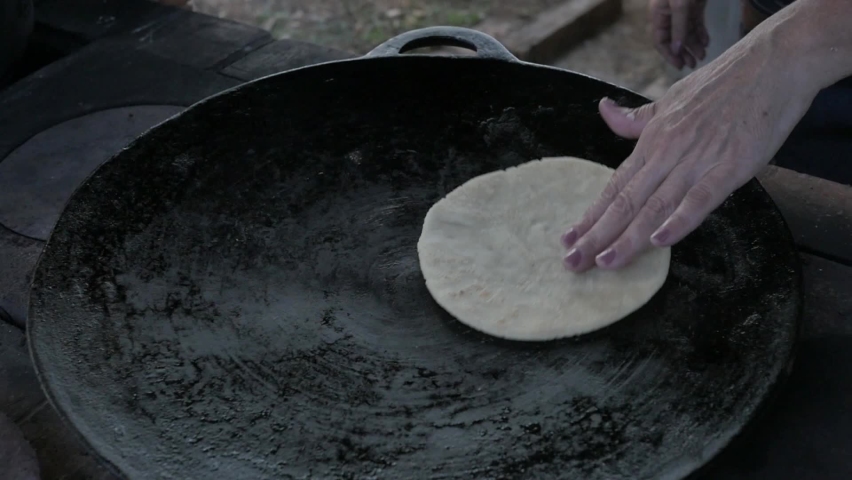 hands making a wheat tortilla in a pan a Costa Rican tradition to accompany a coffee Royalty-Free Stock Footage #1066439104