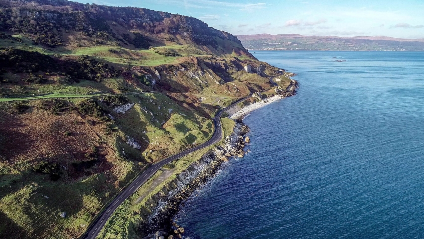 Northern Ireland, UK, Atlantic coast with cliffs. Causeway Coastal Route a.k.a Antrim Coast Road. One of the most scenic coastal roads in Europe. Aerial 4K video. Winter, sunrise light | Shutterstock HD Video #1066457581