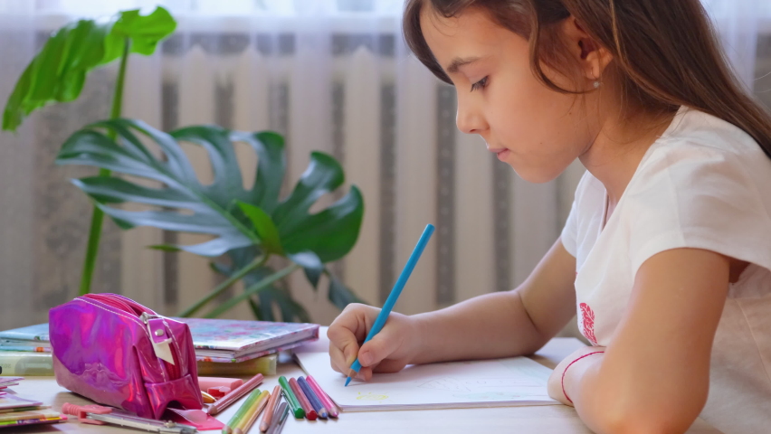 child girl draws with pencils. selective focus.