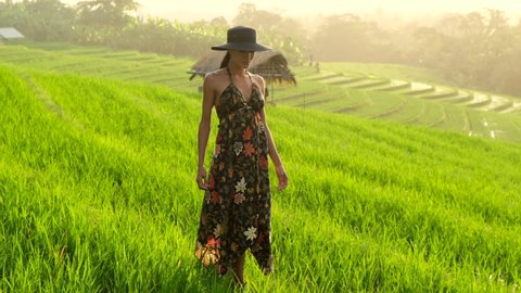 beautiful European woman in a beautiful dress, pregnant, walking on the rice terraces.Harmony with nature. Pregnancy concept.pregnant girl waiting for the birth of a baby, walking in the fresh air,