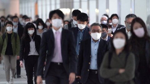 Crowd of businessman walking to work in Tokyo, JAPAN	