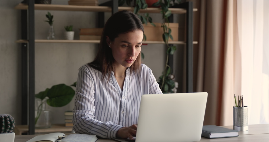 Unhappy young business lady looking at computer screen, feeling confused by failure. Frustrated millennial woman reading email with unpleasant news, stressed by mistake or having problem with device. Royalty-Free Stock Footage #1066472446