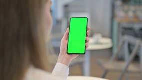 Woman Browsing Smartphone with Green Chroma Key Screen, Rear View 