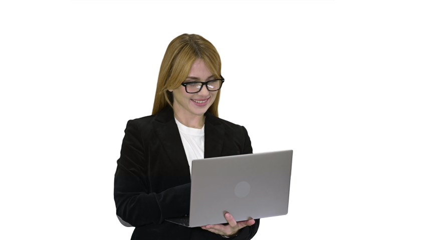 Business woman working on laptop smiling on white background.