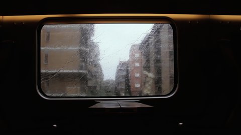 Interior View of an Empty Passenger Wagon in a Moving Train in the Rain in Rome, during the Coronavirus Crisis in Italy. 4K Resolution. 