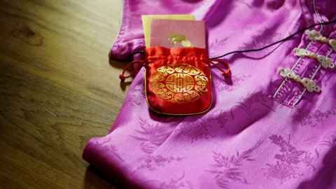 qipao for woman and new year lucky bag with red envelope during chinese new year