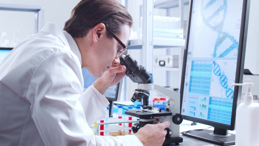 Professional scientist is working on a vaccine in a modern scientific research laboratory. Genetic engineer workplace. Futuristic technology and science concept. | Shutterstock HD Video #1066500157
