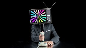 Mr Television head playing computer games using joystick and hypnotic pattern on the screen