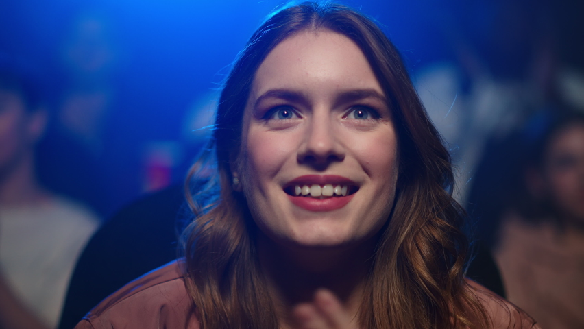 Closeup amazed woman applauding at movie premiere in dark hall. Portrait of smiling girl enjoying film in movie theater. Happy female person spending evening in cinema. | Shutterstock HD Video #1066504438