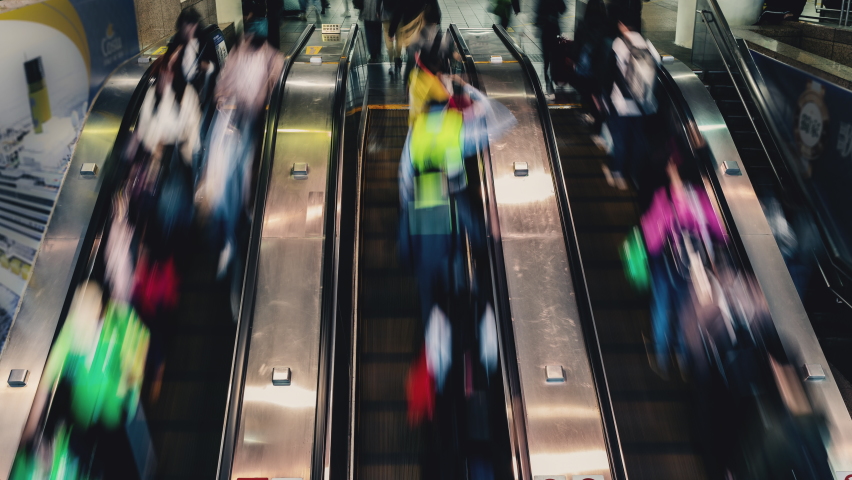 Crowd of passengers wearing masks, walking escalators in subway station at busy hours  Royalty-Free Stock Footage #1066506307
