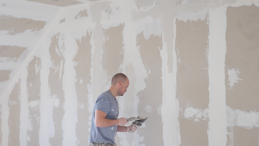 Working process of plasterboard drywall for making gypsum walls in apartment under construction, remodelling, renovation, extension, restoration and reconstruction. DIY concept. Drywall installation Royalty-Free Stock Footage #1066506472