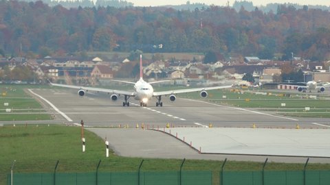 Airplane takeoff on runway in Switzerland - Airbus A340