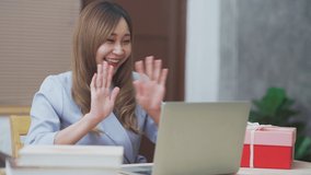 Asian young woman got present giftbox from her boyfriend while talking with laptop for new normal concept