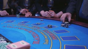 A large gaming table table in a casino. Men and women at the casino gaming table place bets with playing chips. - Powered by Shutterstock - Get 15% off with code: PIKWIZARD15