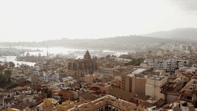 Old town in Palma on the island of Mallorca Spain dron 4K video. Aerial view of historic streets with houses, Mediterranean seafront church with beautiful urban landscape.