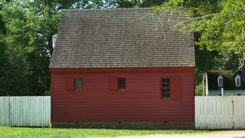 Historic Red House with White Fence Window