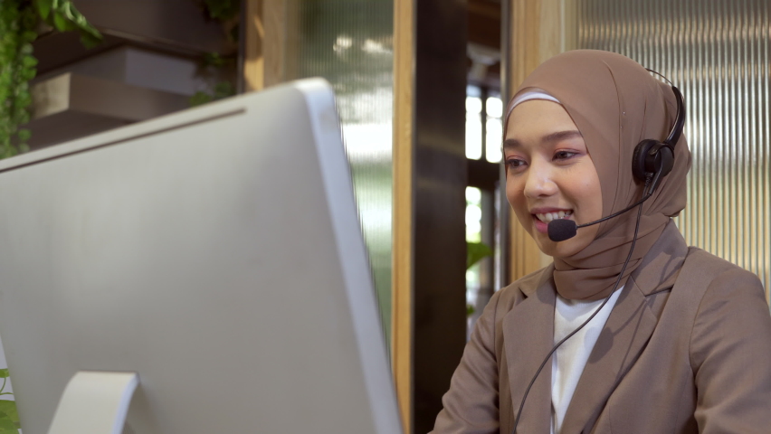 Beautiful asian muslim women wearing hijab working in call center office, Confident islam woman worker in Customer Support smiling joyful to Support Customers Royalty-Free Stock Footage #1066536721