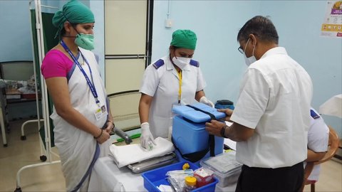 MUMBAI-INDIA - January 16, 2021: A staff member of the Rajawadi Hospital getting ready before the start of the Covid-19 coronavirus vaccination drive.