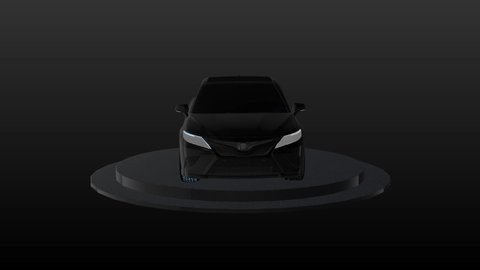 A black Toyota Camry stands on a stand and spins around on its axis. Presentation of a business class car. Car business: Chita . Russia. 01.02.2021