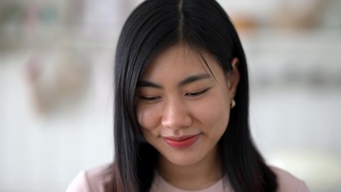 Close-up of beautiful young asia woman laugh and smiling. young woman face looking at the camera.