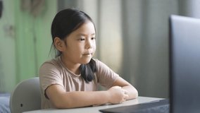 Asian child student or kid girl enjoy talk or singing on computer notebook for e-learning communication or study online and people learn from home to playing laptop for education by back to school 4K