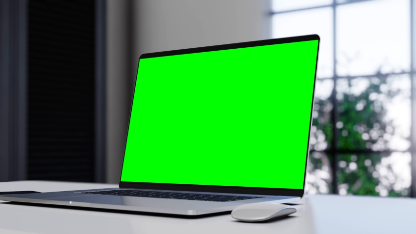 Laptop with blank green screen in office interior. Smooth camera movement around object with bokeh background. Home interior or office, 4k 24fps UHD Royalty-Free Stock Footage #1066565413