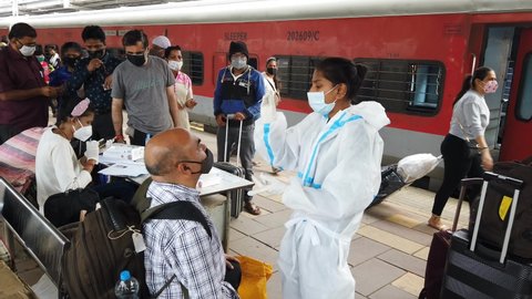 MUMBAI-INDIA - January 18, 2021: Health workers takes a nasal swab sample of an arriving passenger to test for COVID-19 at Dadar station.
