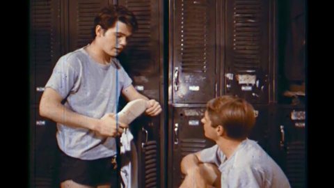 CIRCA 1960s - In a locker room, two teenage boys talk about how they wish they had bigger penises in 1966.