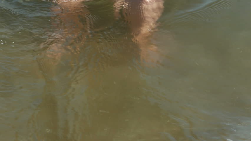 Ocean Waves Washing Over Childs Feet in Slow Motion