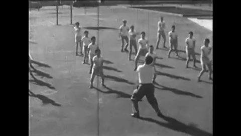 CIRCA 1950s - A narrator explains the importance and simplicity of rhythmic exercises as boys complete them in 1950.