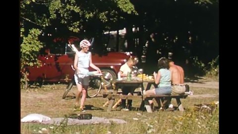 CIRCA 1960s - Families set up camp at a farm-turned-campsite in 1965, located in scenic upstate New York.