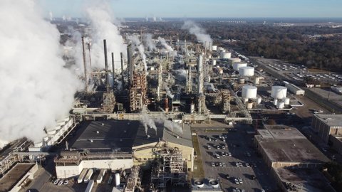 LOUISIANA - CIRCA 2020 - good aerial over a huge oil refinery along the Mississippi River in Louisiana suggests industry, industrial, pollution.