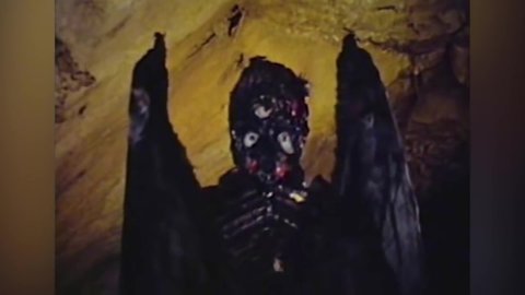 CIRCA 1967 - In this sci-fi film, a woman goes into a cave to search for a monster and is scared by an alien.