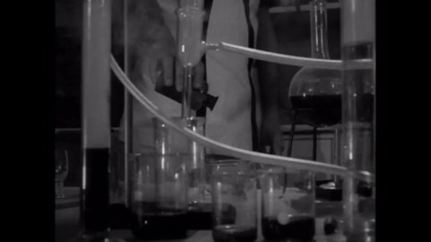 CIRCA 1969 - In this sci-fi film, a mad scientist watches a brain in a bubbling jar in his lab.