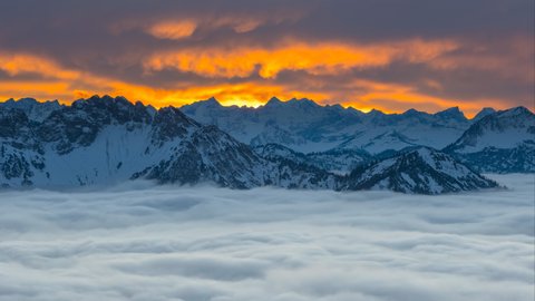 Alps panorama winter with snow at sunset colored sky, foggy nature landscapes landscapes 8k video, germany austria alps mountains.
