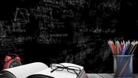 Animation of mathematical drawings and symbols over blackboard with book, glasses and coloured pencils on desk. education schooling and knowledge concept digitally generated video.