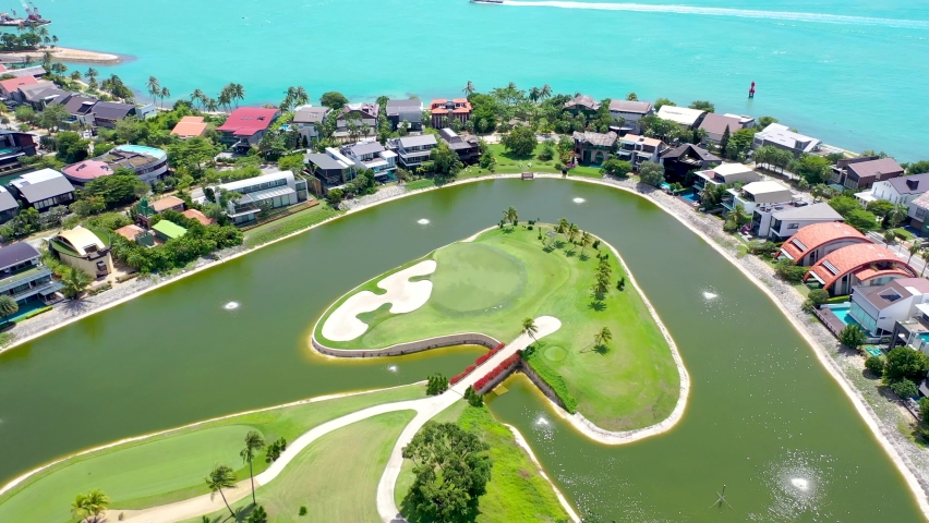 SINGAPORE : Top view of houses on the palm beach. Shot. Top view of the sea with palm trees and luxury hotel. Aerial Top view landscape