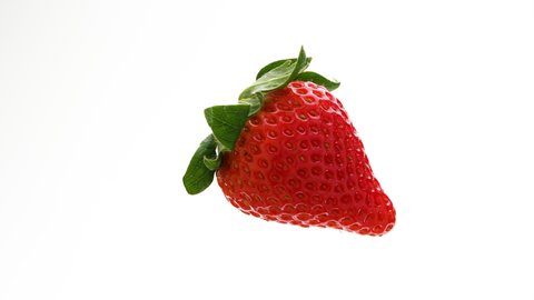 Video shot while turning strawberries on white background