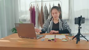 Asian business woman in video call online conference in meeting talking to colleague discussing work on sales marketing planning creative innovation ideas, working at home modern office quarantine.