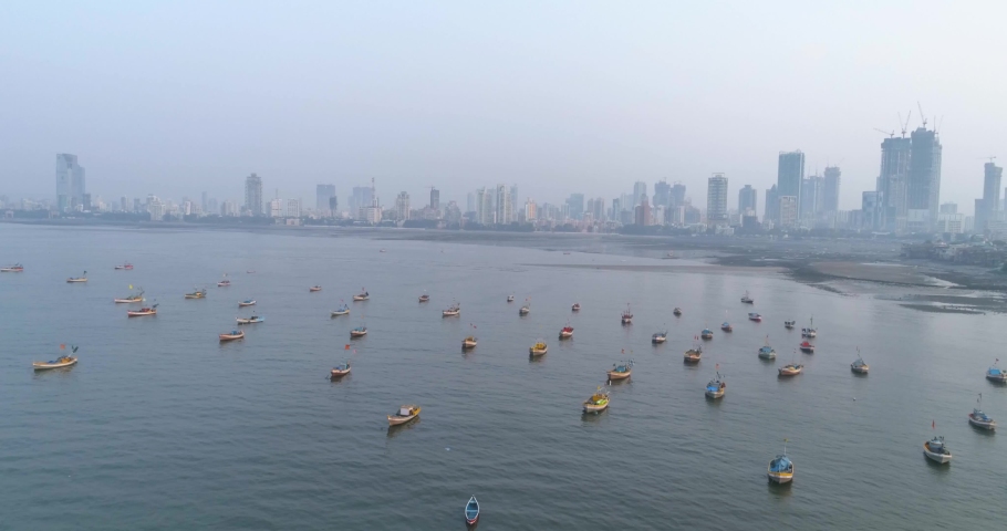 A drone shot at Bandra Worli Sea Link seen from an aerial view in slow motion. Cinematic drone movement with the iconic Mumbai Sea Link at the forefront and the city view in the background. Royalty-Free Stock Footage #1066603405