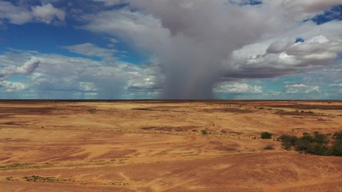 Drone footage of cloudburst over dry Western Queensland outback plain