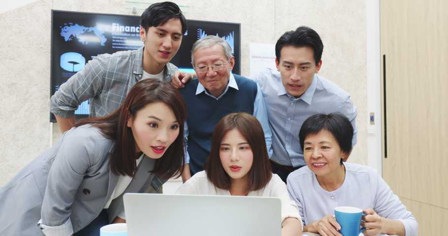 Group meeting of startup company brainstoming about website interface workflow and use laptop to complete the system test sucessfully